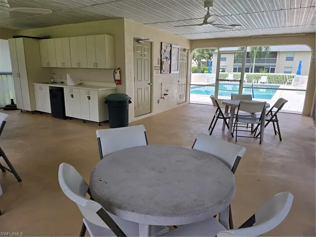 a view of house with swimming pool and outdoor seating