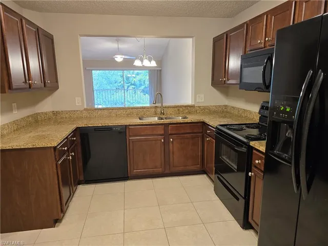 a kitchen with a sink cabinets and stainless steel appliances