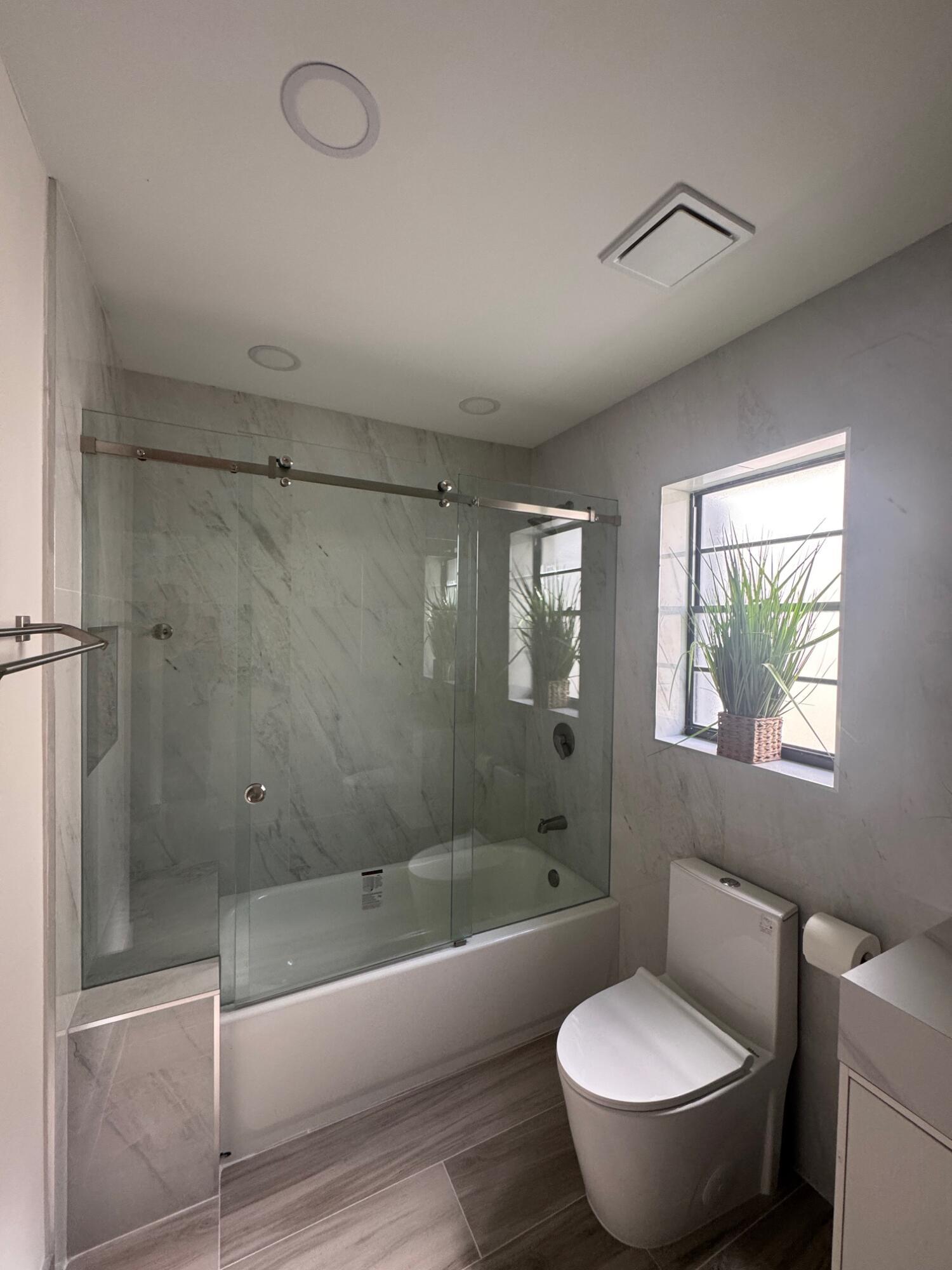 8711 Eagle Run Drive Boca Raton, FL 33434 - Photo 11 of 17 a bathroom with a tub toilet and a shower