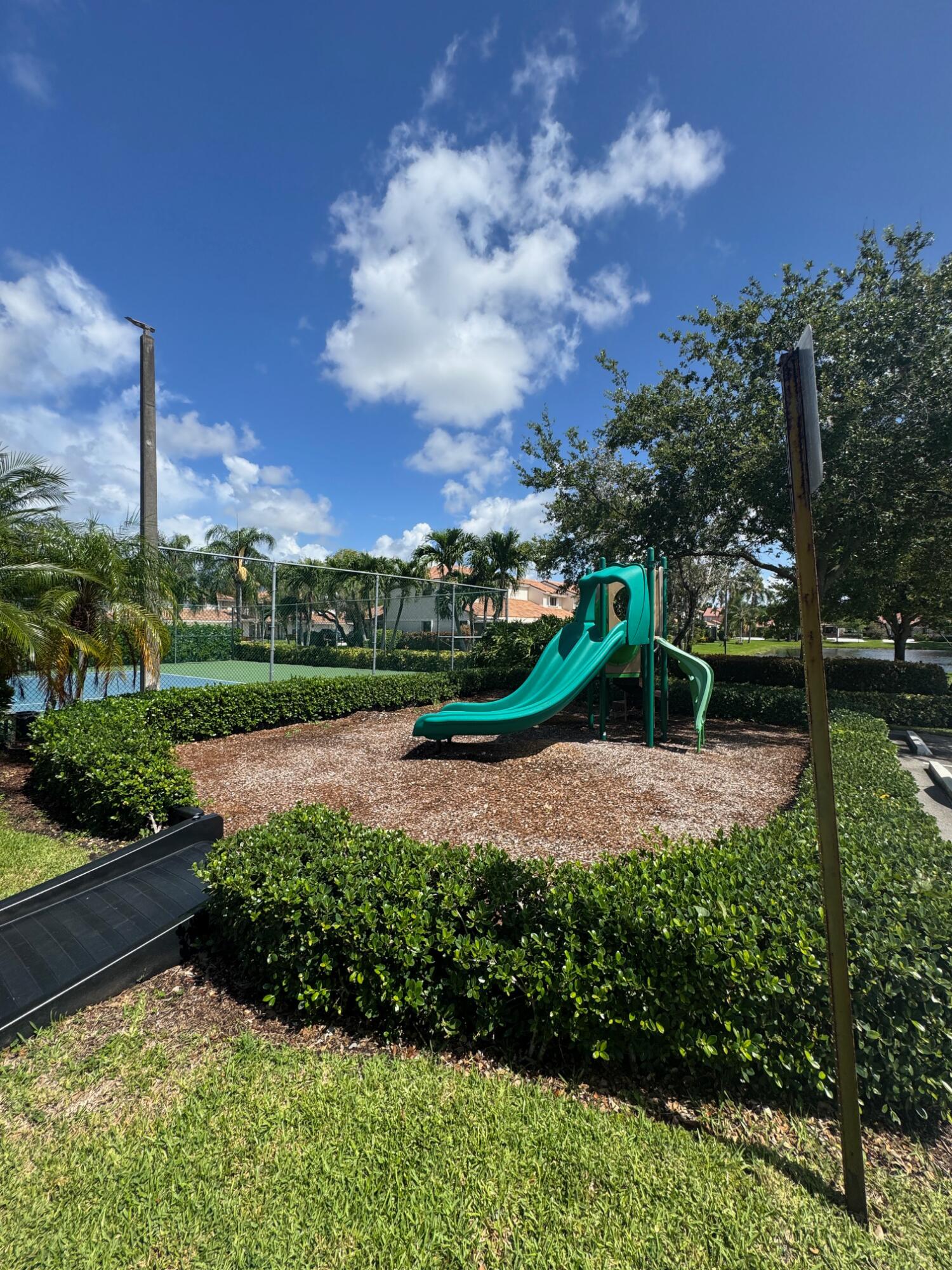 8711 Eagle Run Drive Boca Raton, FL 33434 - Photo 16 of 17 a view of a garden with a lake