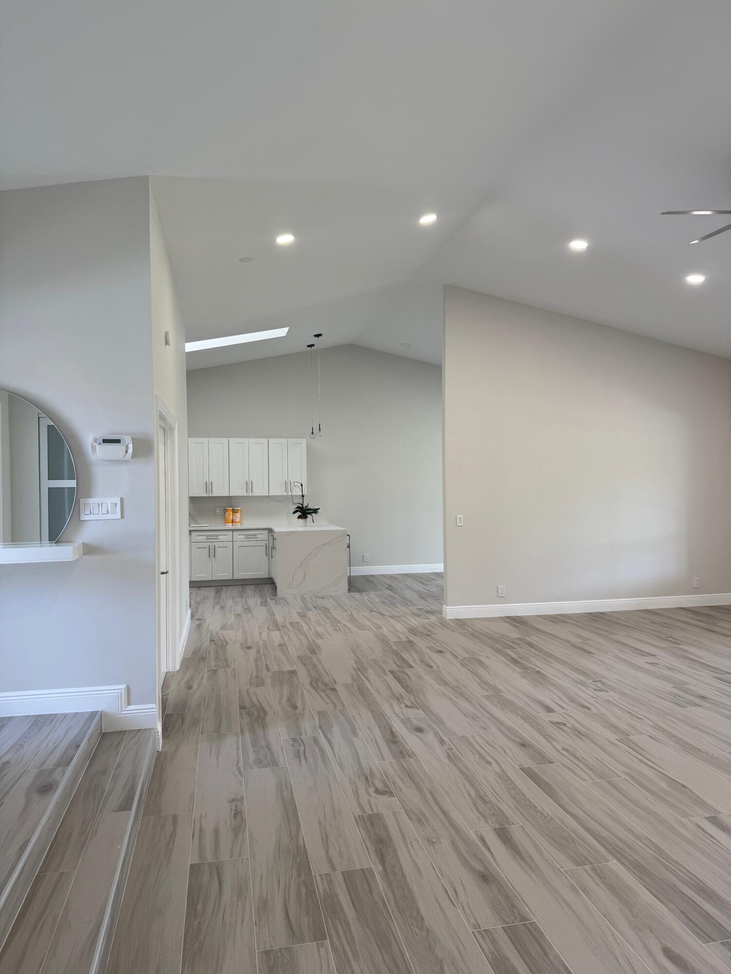 8711 Eagle Run Drive Boca Raton, FL 33434 - Photo 4 of 17 a view of a kitchen with kitchen island a sink wooden floor and appliances