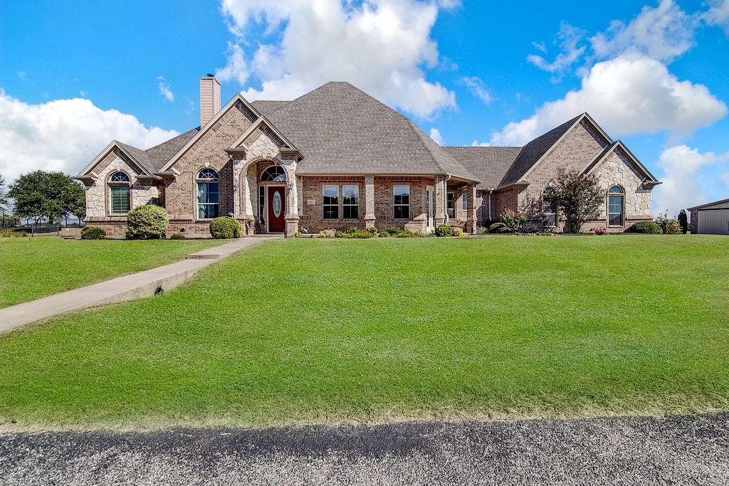 117 Citation Drive Cresson, TX 76035 - Photo 1 of 40 French provincial home featuring a front yard, brick siding, a shingled roof, a chimney, and stone siding