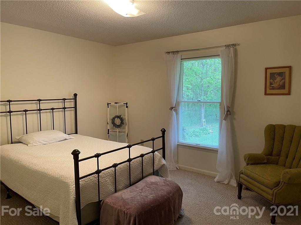 224 Lynch Street Rutherfordton, NC 28139 - Photo 11 of 23 a bedroom with a bed and a couch