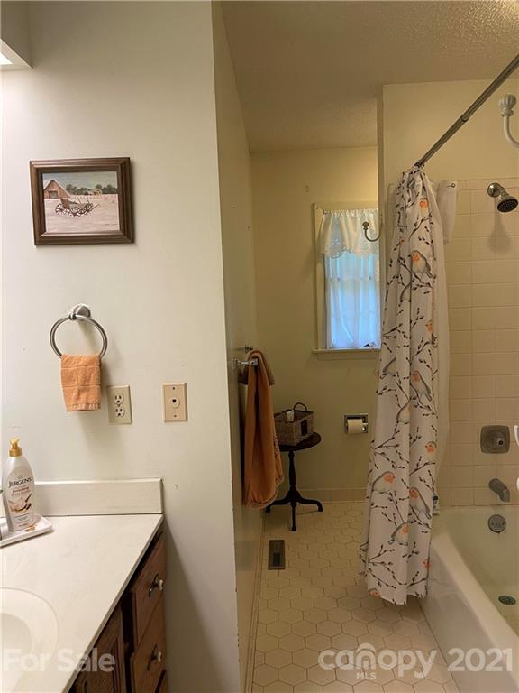 224 Lynch Street Rutherfordton, NC 28139 - Photo 16 of 23 a bathroom with a sink mirror and tub
