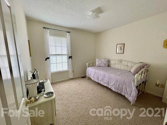 224 Lynch Street Rutherfordton, NC 28139 - Photo 17 of 23 a bedroom with a bed and cabinets