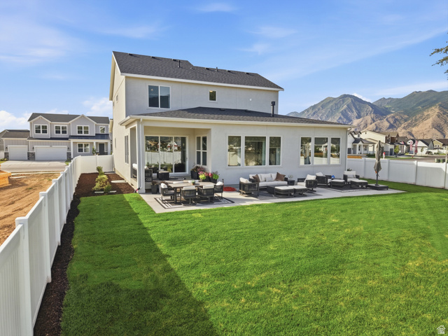2559 West Aurora Avenue Mapleton, UT 84664 - Photo 59 of 60 Spacious backyard featuring a manicured lawn, an extended concrete patio, and a white vinyl privacy fence