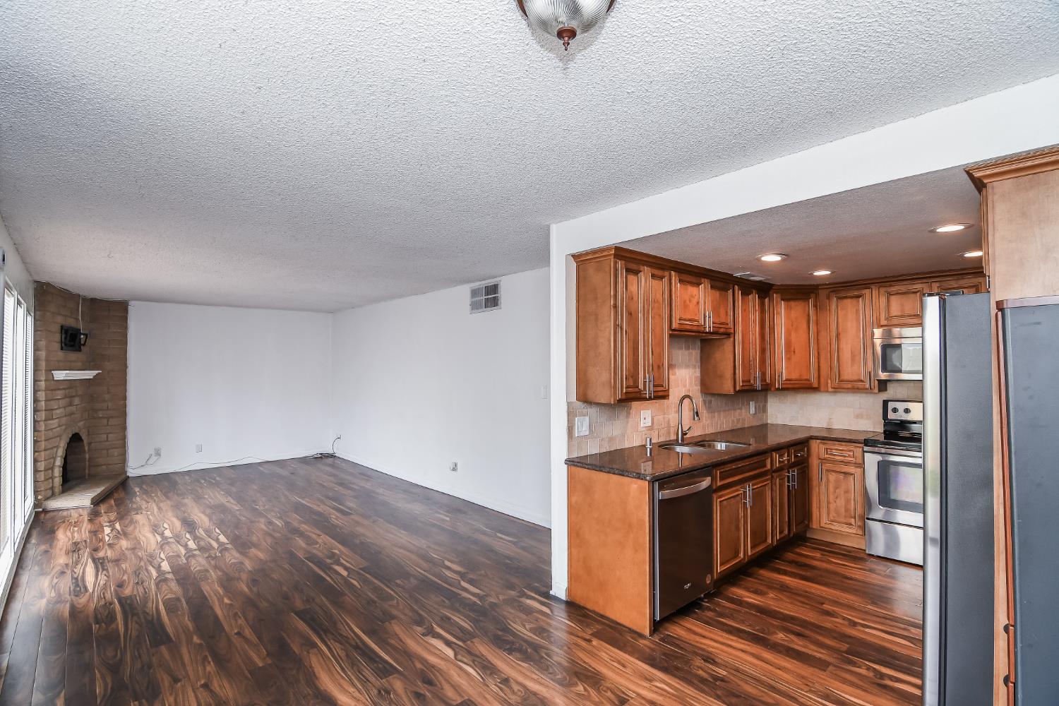 1139 Rivara Circle Sacramento, CA 95864 - Photo 18 of 72 a kitchen with stainless steel appliances granite countertop a stove a sink and a refrigerator