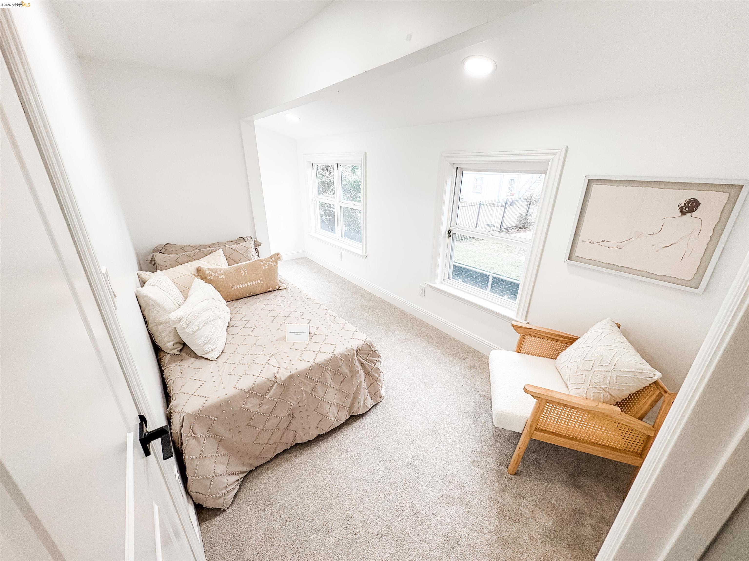 1812 Woolsey Street Berkeley, CA 94703 - Photo 20 of 48 Bright interior space featuring two windows, recessed lighting, white trim, and light-colored carpeting