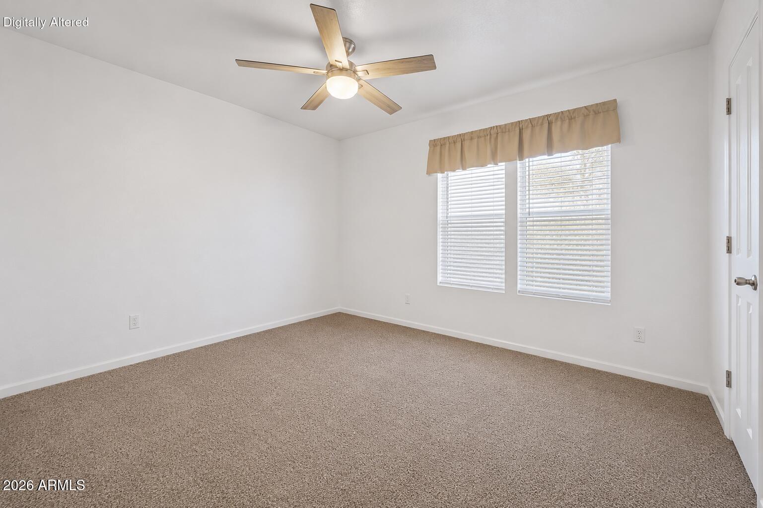 625 West McKellips Road, Unit 55 Mesa, AZ 85201 - Photo 10 of 21 an empty room with a window and a ceiling fan
