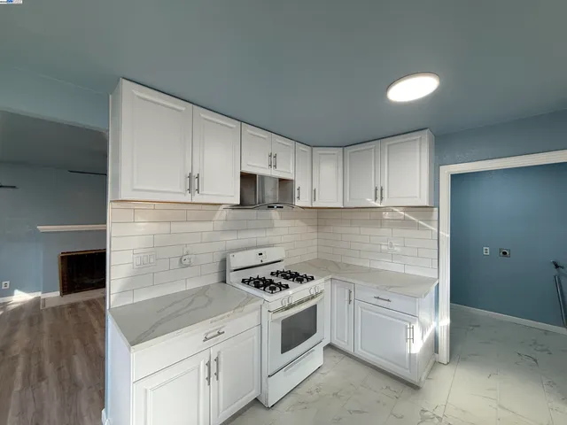 a kitchen with cabinets appliances and a counter space