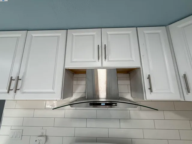 a view of a utility room with cabinets
