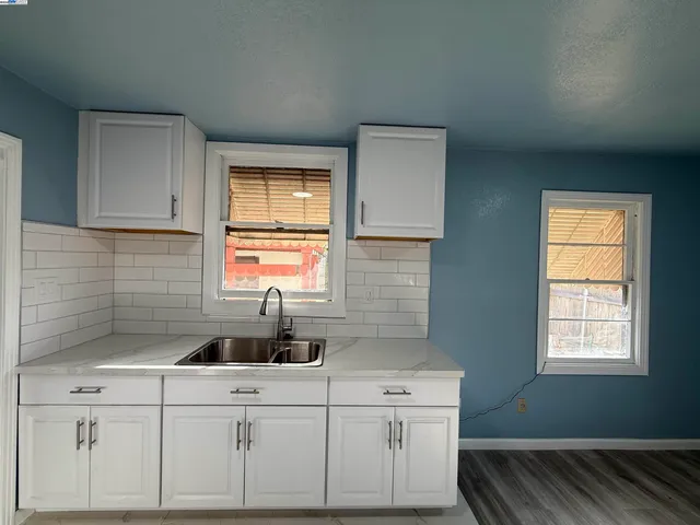 a kitchen with a sink cabinets and window