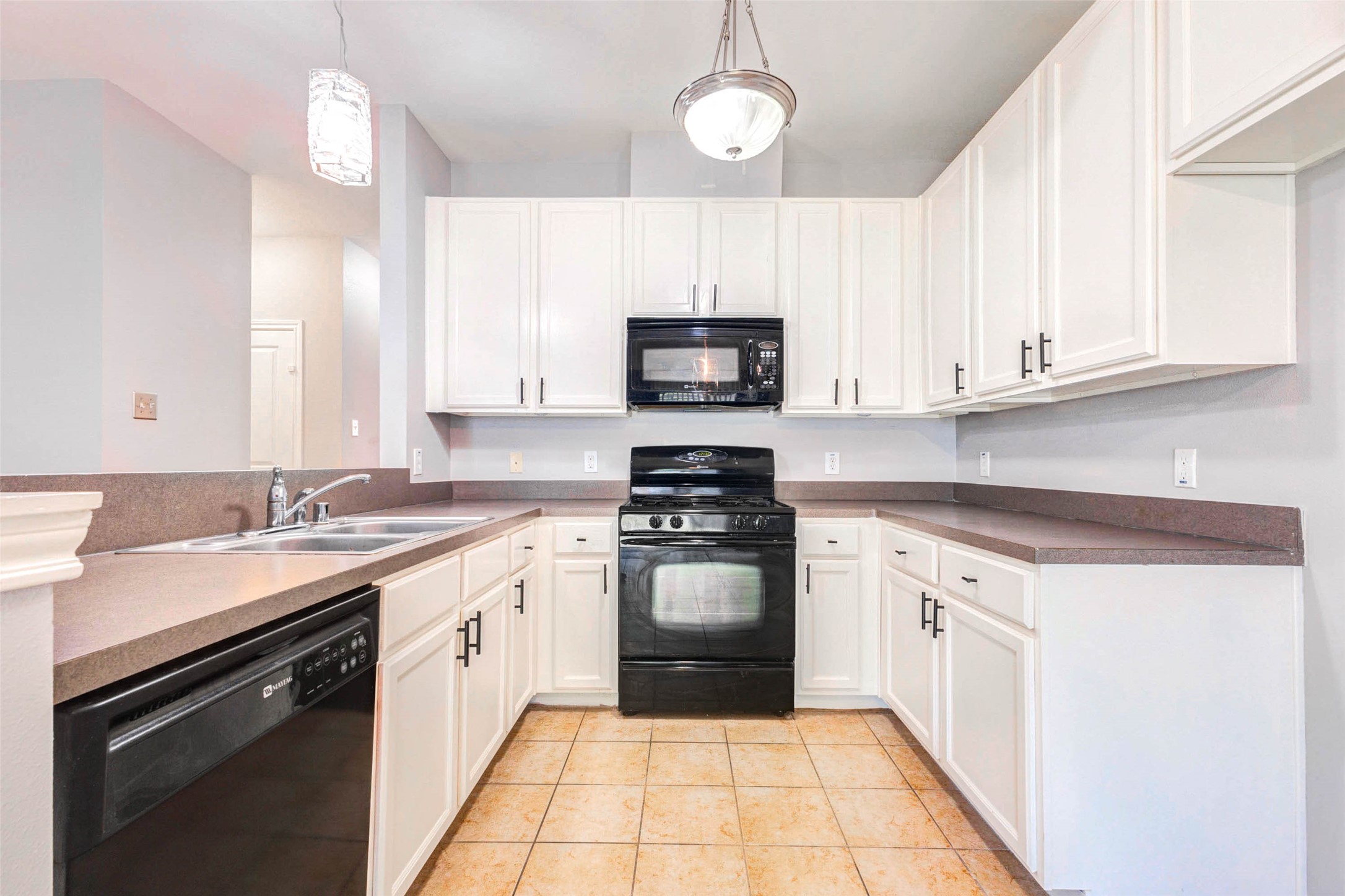 14522 Durham Chase Lane Houston, TX 77095 - Photo 12 of 40 a kitchen with a sink stove and microwave