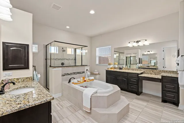a large kitchen with kitchen island granite countertop a sink and cabinets