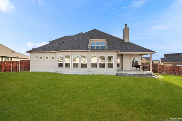 a view of a house with a yard and sitting area
