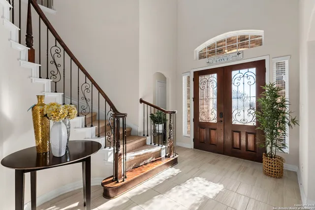 a view of entryway and hall with a front door
