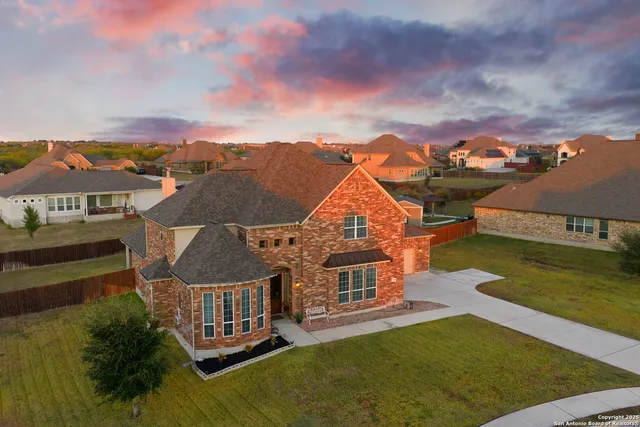 an aerial view of a house with swimming pool lake view and mountain view