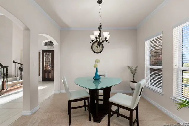 a view of a dining room with furniture and chandelier