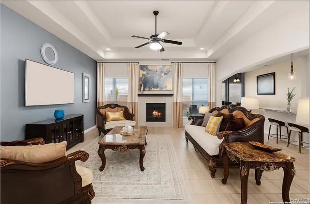 a living room with furniture a fireplace and a flat screen tv