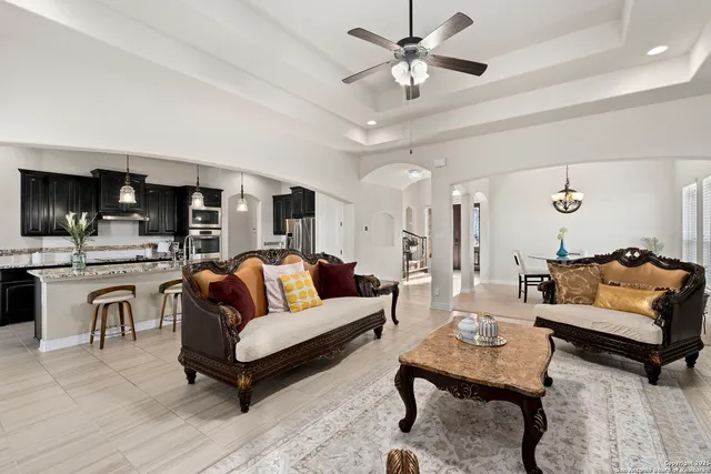 a living room with furniture and view of kitchen