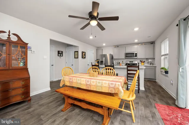 a view of a dining room with furniture and wooden floor