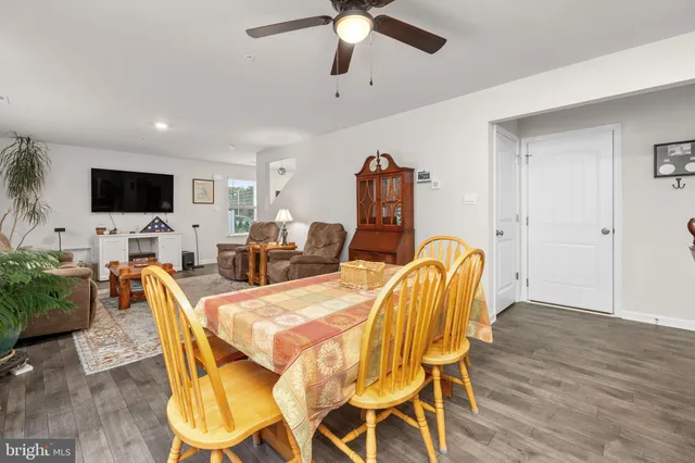 a kitchen with kitchen island a appliances dining table and chairs