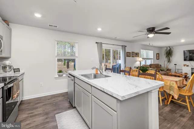 a bathroom with a sink and mirror with toilet