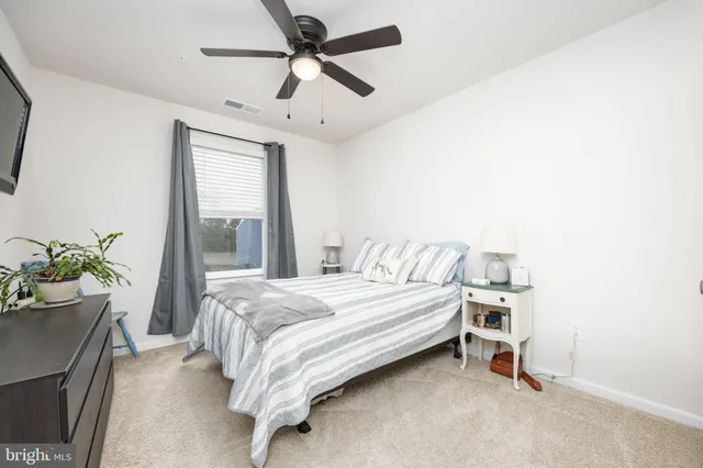 a bedroom with furniture and a painting on the wall