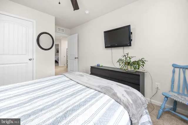 a spacious bedroom with a bed and a chandelier