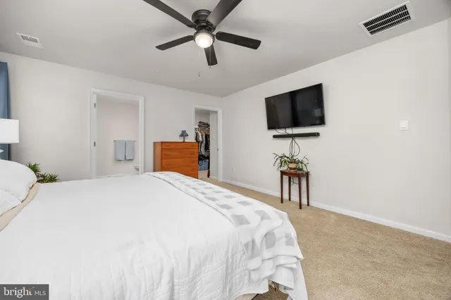 a spacious bathroom with a sink a mirror and a shower
