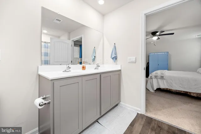 a view of a swimming pool with a lounge chair and dinning table under an umbrella