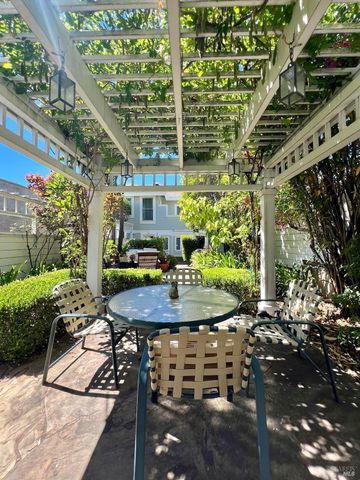 a view of a patio with table and chairs potted plants with wooden floor and fence