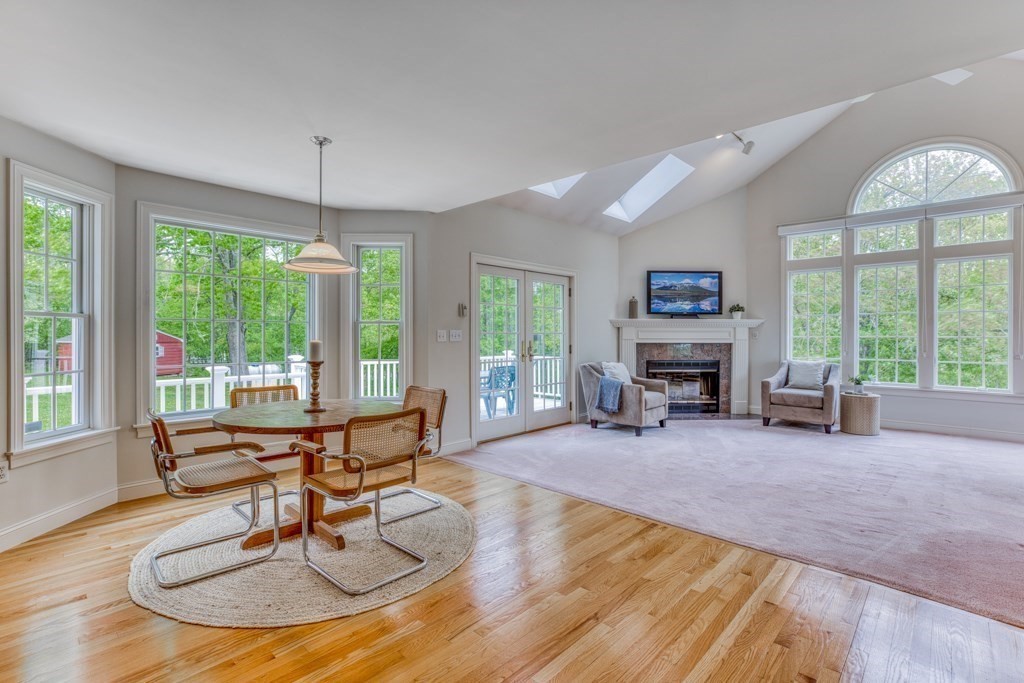 51 Glendale Road Boxford, MA 01921 - Photo 12 of 37 a living room with furniture a fireplace and floor to ceiling windows