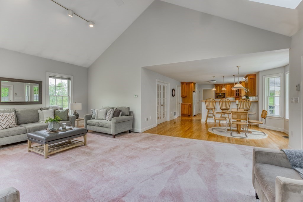 51 Glendale Road Boxford, MA 01921 - Photo 16 of 37 a spacious bedroom with a bed a couch and a potted plant on the dresser
