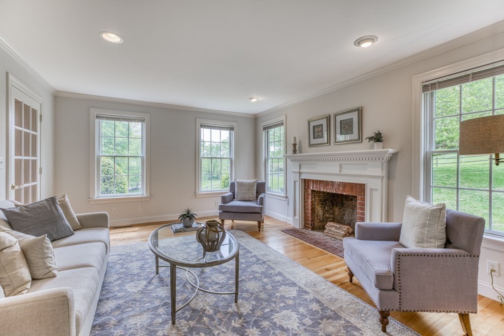 51 Glendale Road Boxford, MA 01921 - Photo 6 of 37 a living room with furniture a large window and a fireplace