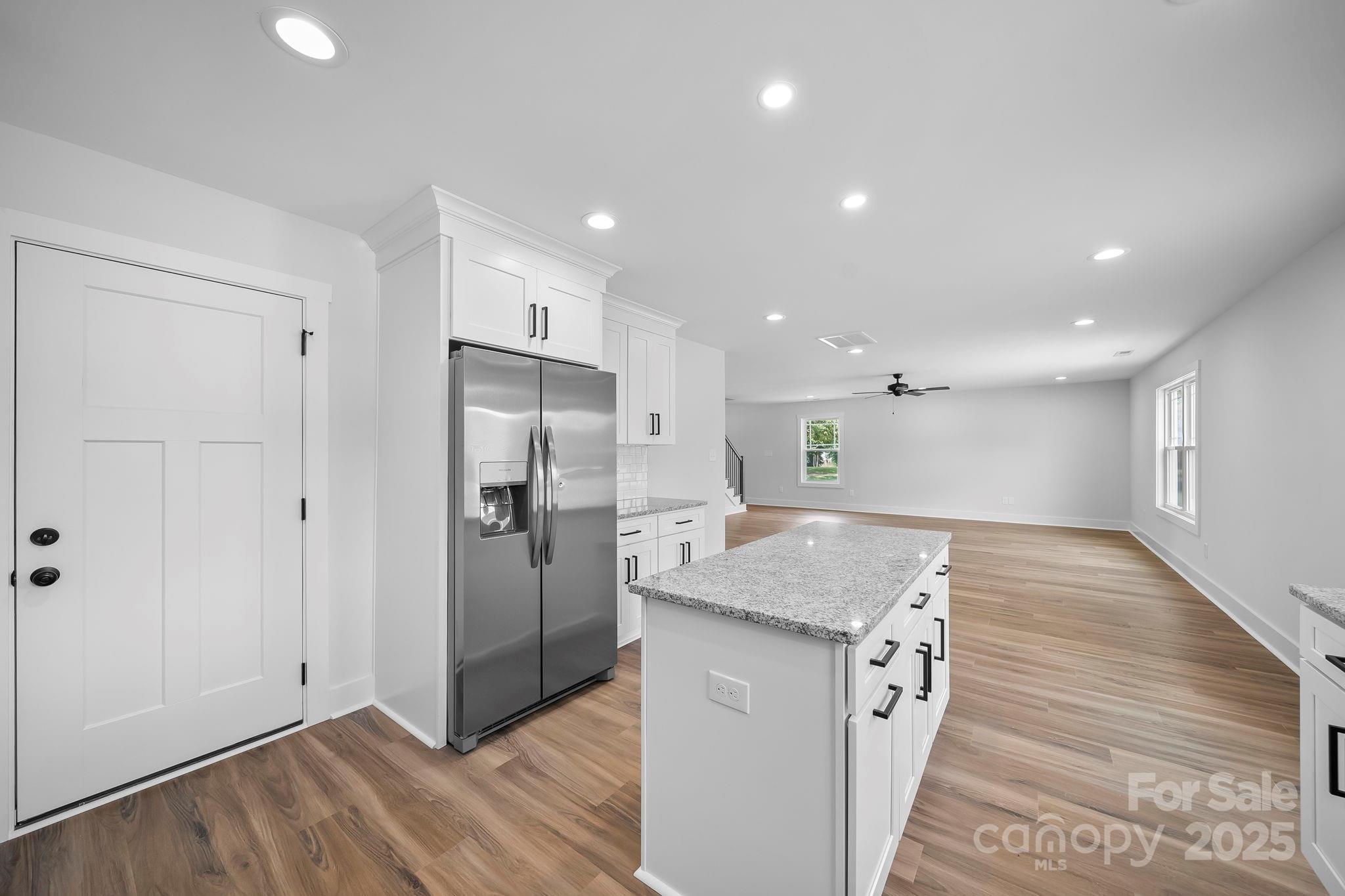 1312 Austin Chaney Road Wingate, NC 28174 - Photo 14 of 47 a view of kitchen island wooden floor center island and stainless steel appliances