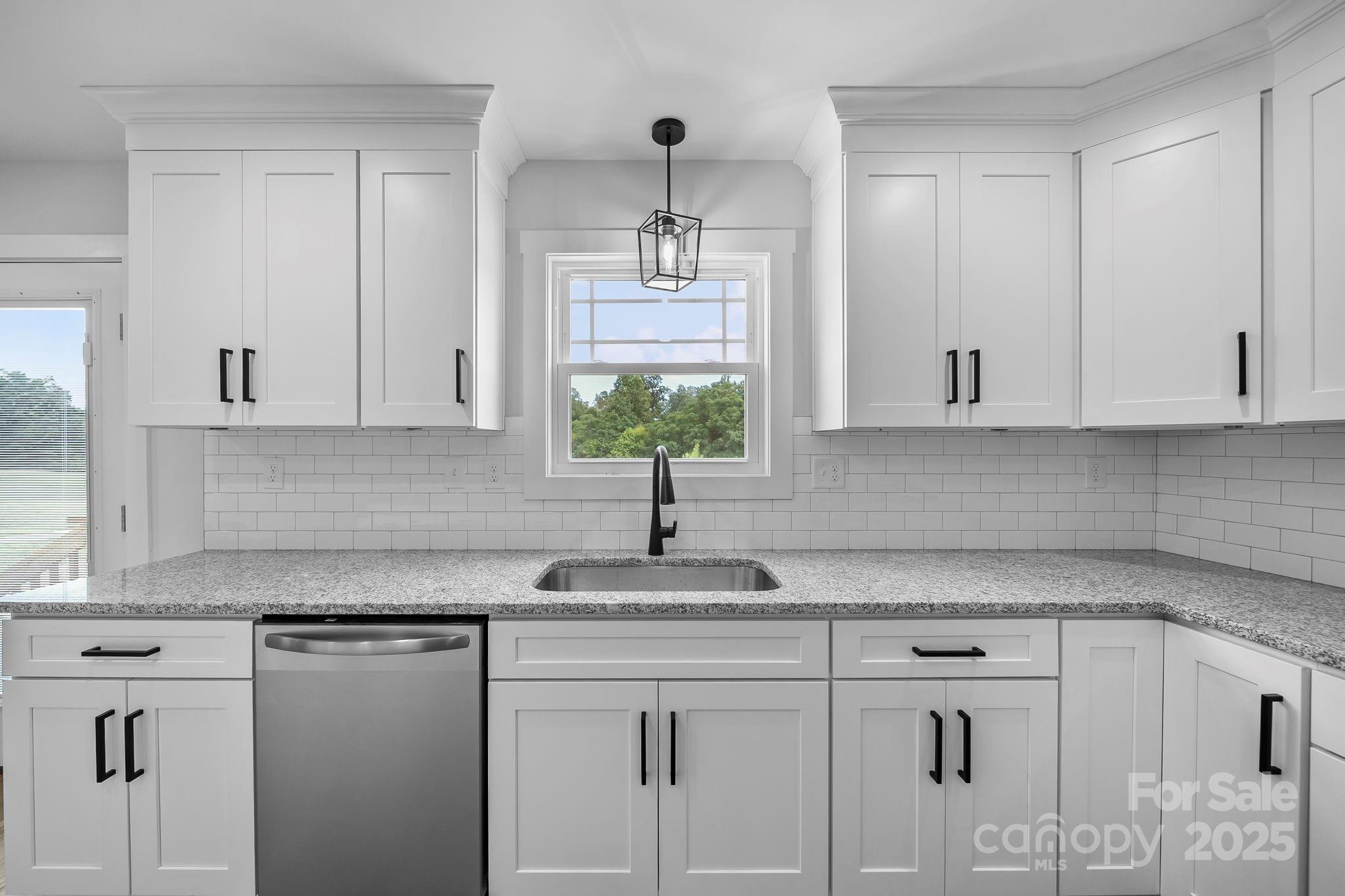 1312 Austin Chaney Road Wingate, NC 28174 - Photo 16 of 47 a kitchen with white cabinets white appliances and a sink
