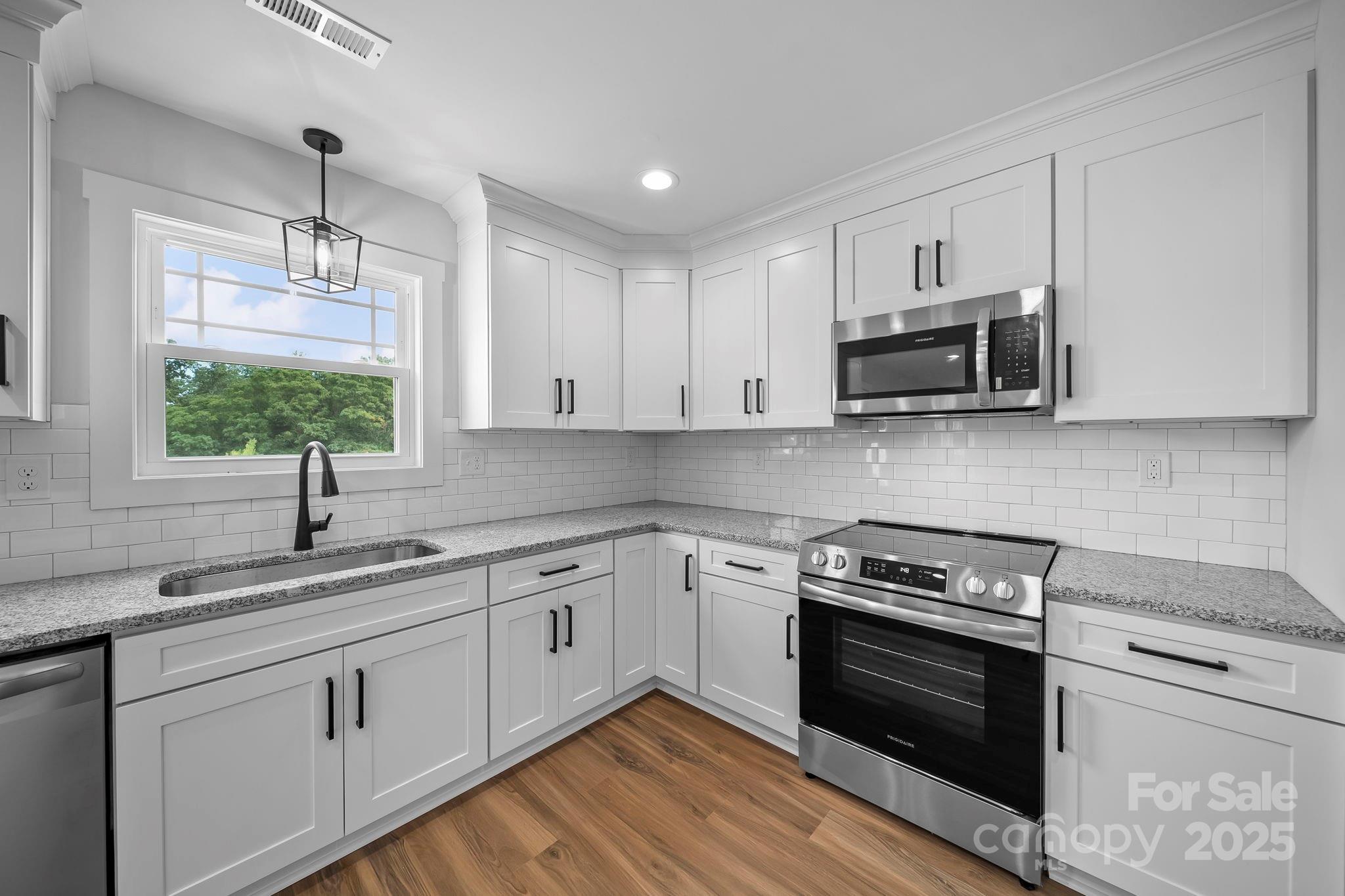 1312 Austin Chaney Road Wingate, NC 28174 - Photo 17 of 47 a kitchen with appliances cabinets and a sink