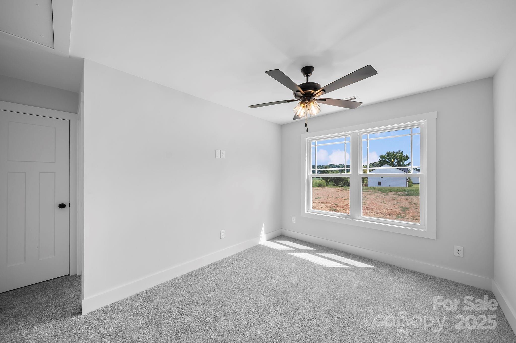 1312 Austin Chaney Road Wingate, NC 28174 - Photo 29 of 47 an empty room with window and ceiling fan