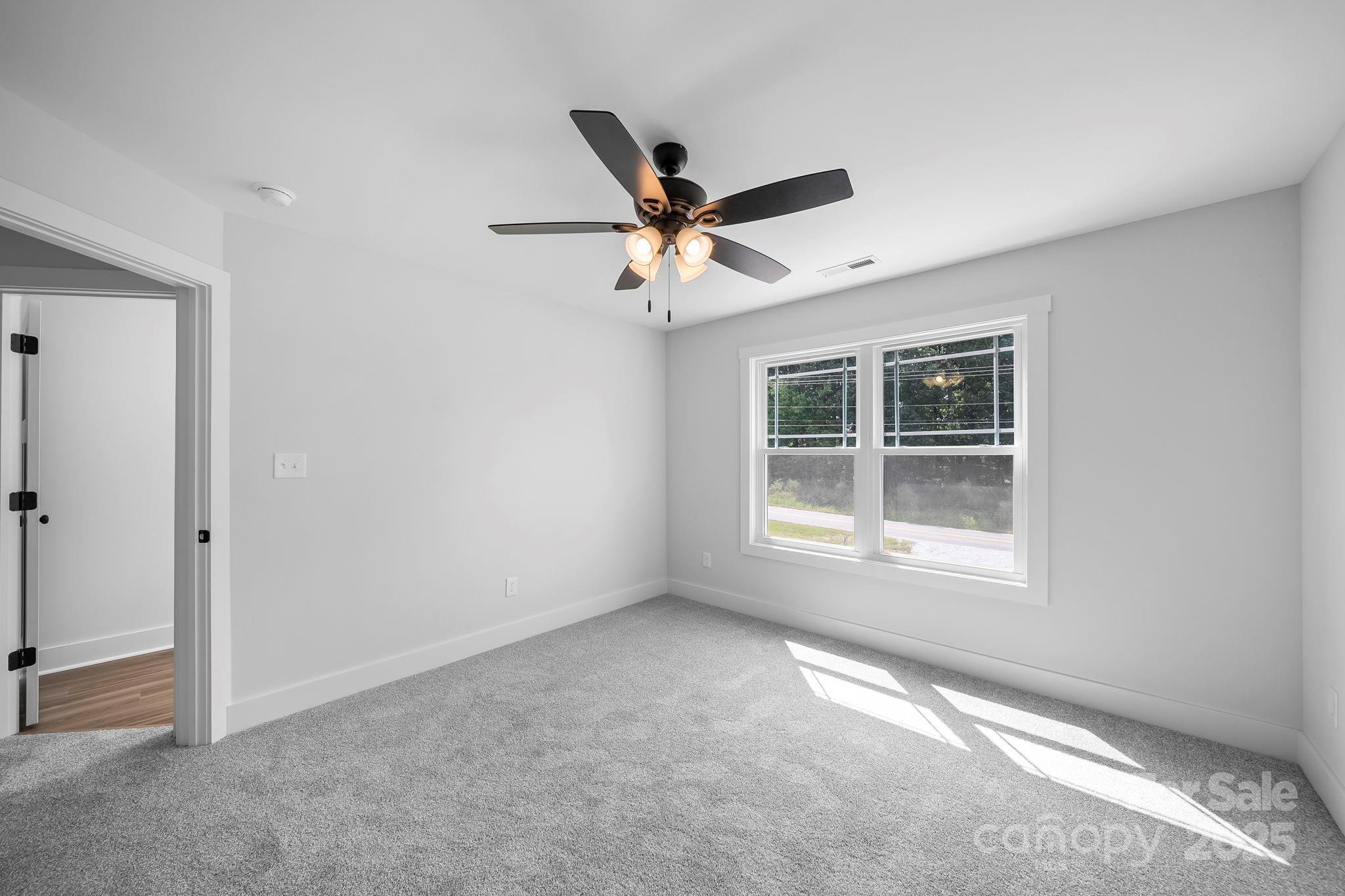 1312 Austin Chaney Road Wingate, NC 28174 - Photo 33 of 47 an empty room with a window and a fan