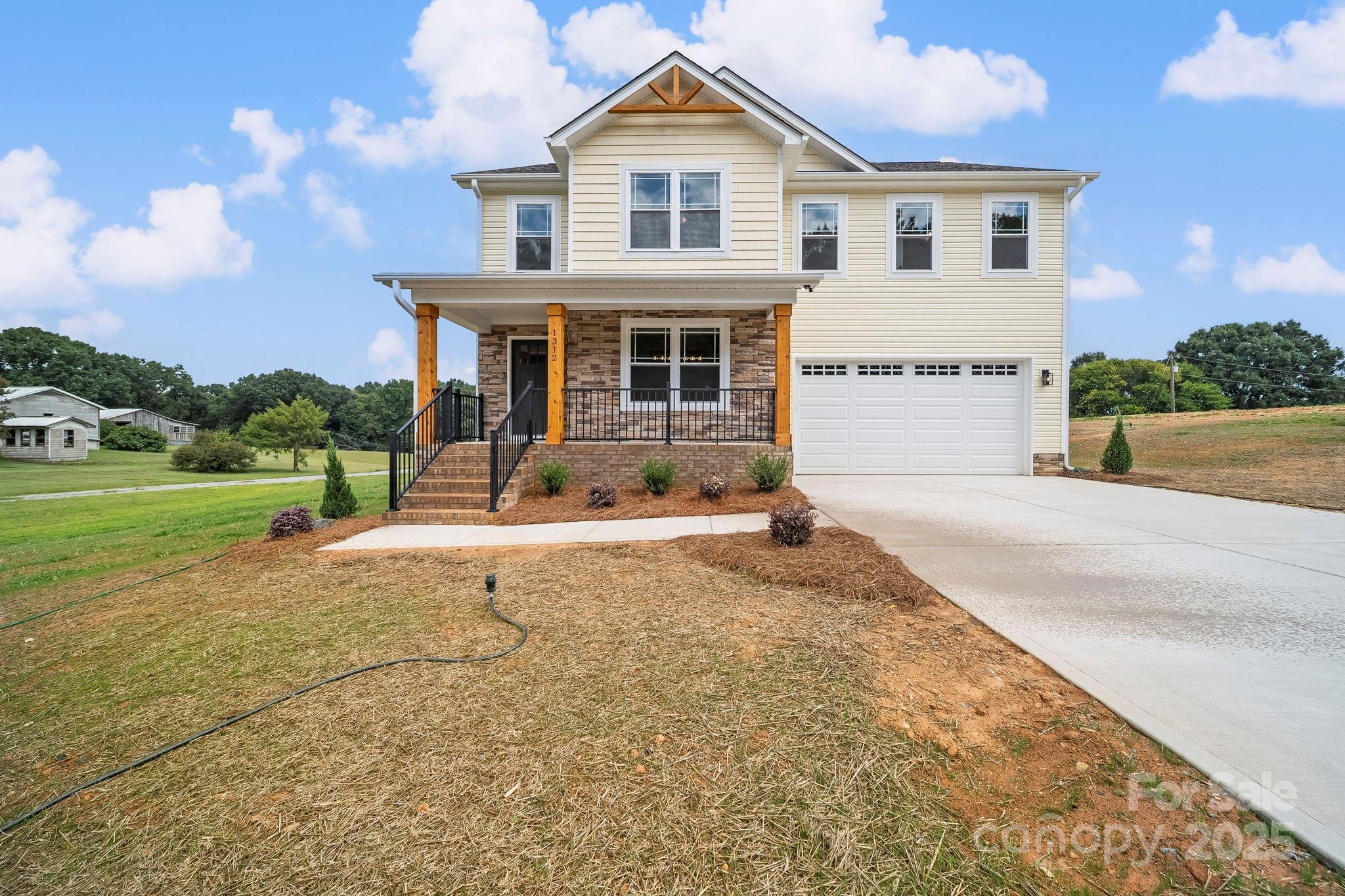 1312 Austin Chaney Road Wingate, NC 28174 - Photo 4 of 47 a front view of a house with a yard and garage