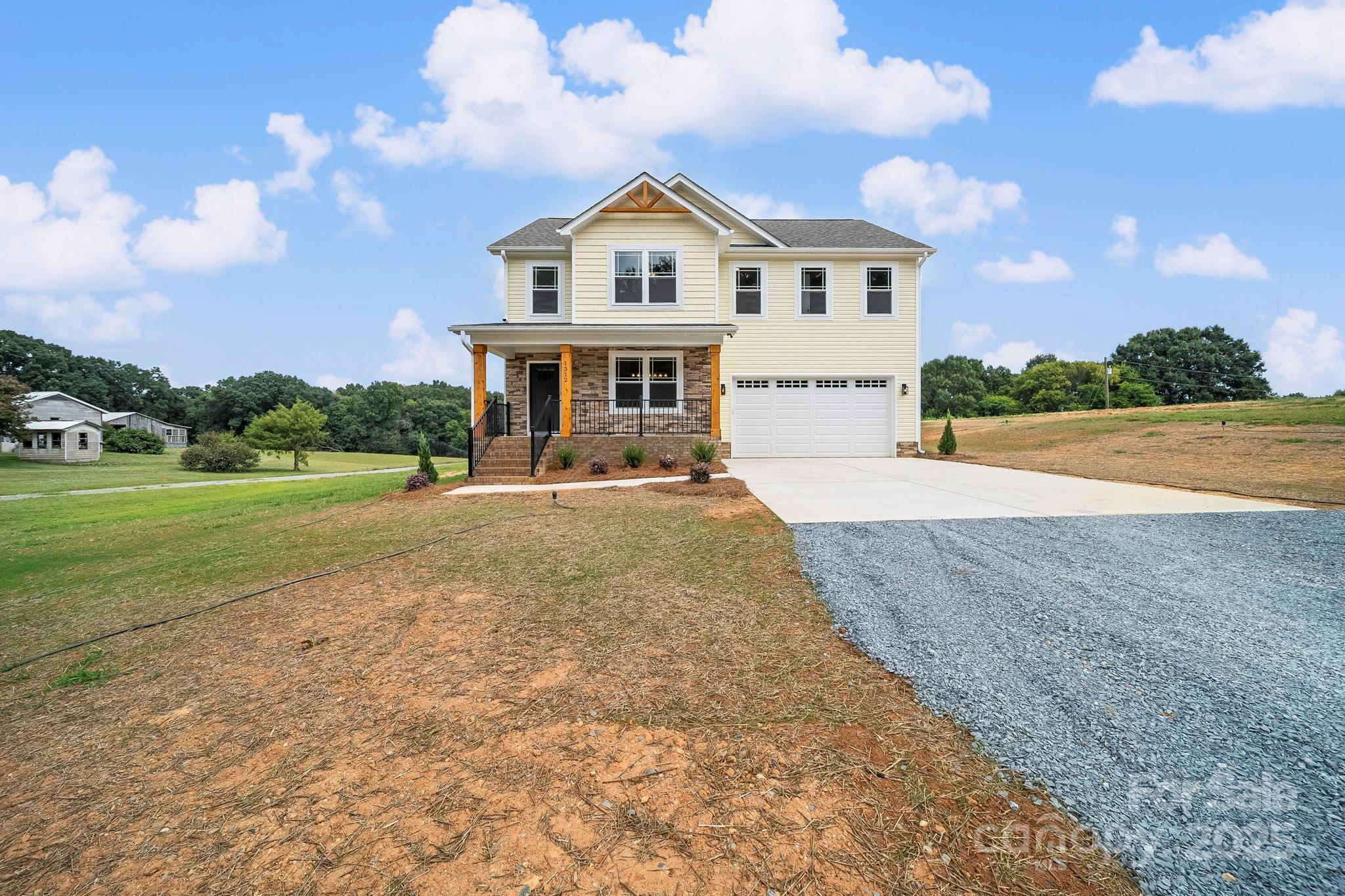 1312 Austin Chaney Road Wingate, NC 28174 - Photo 43 of 47 a front view of a house with a yard and garage