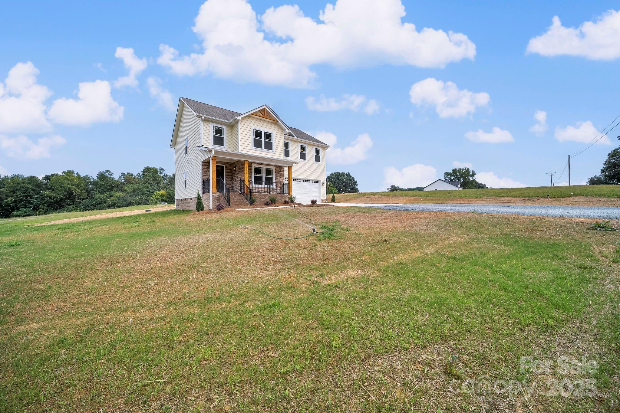 1312 Austin Chaney Road Wingate, NC 28174 - Photo 44 of 47 a view of a big house with a big yard and large trees