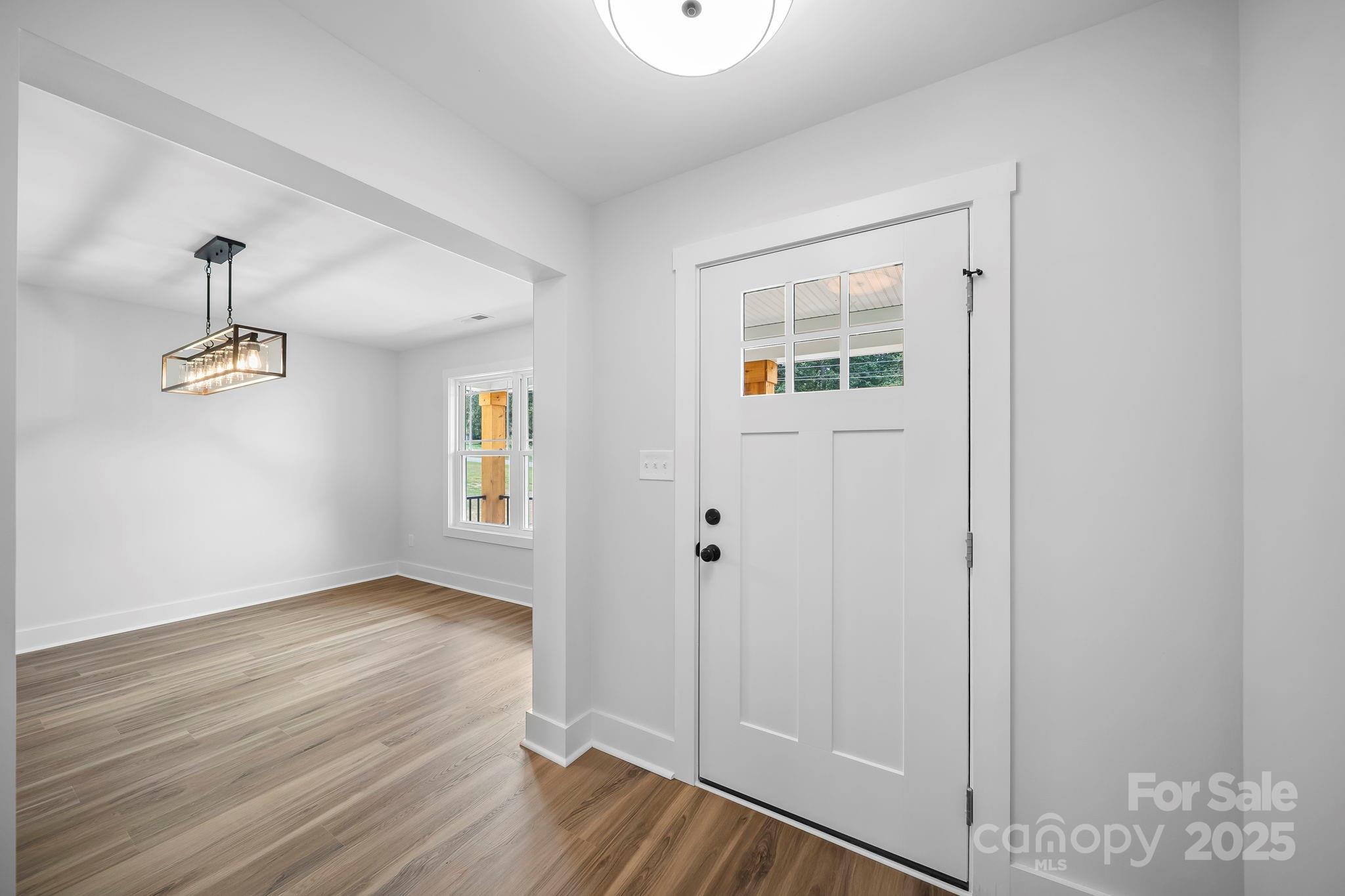 1312 Austin Chaney Road Wingate, NC 28174 - Photo 6 of 47 a view of an empty room with wooden floor and a window
