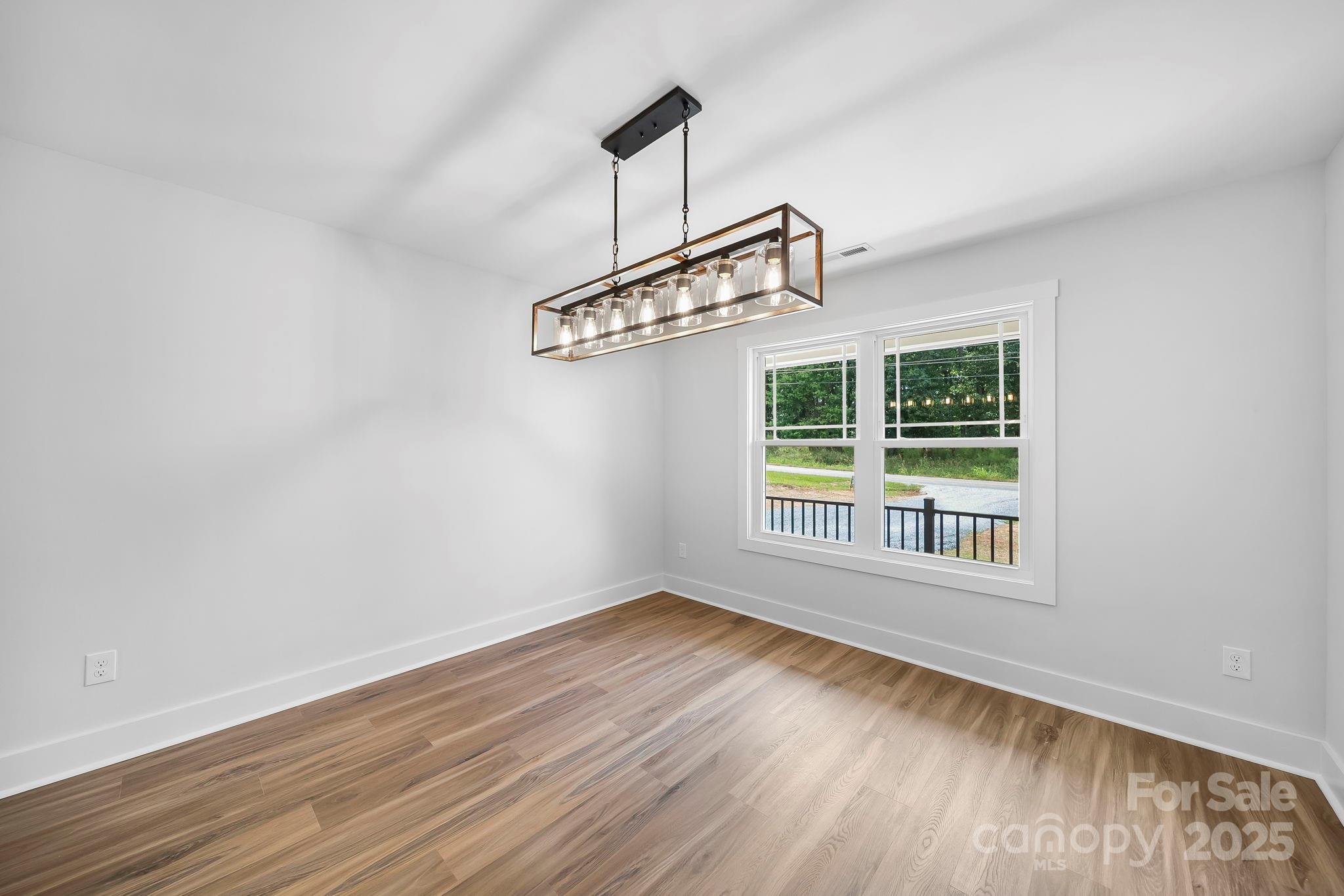 1312 Austin Chaney Road Wingate, NC 28174 - Photo 7 of 47 a view of a room with wooden floor and a window