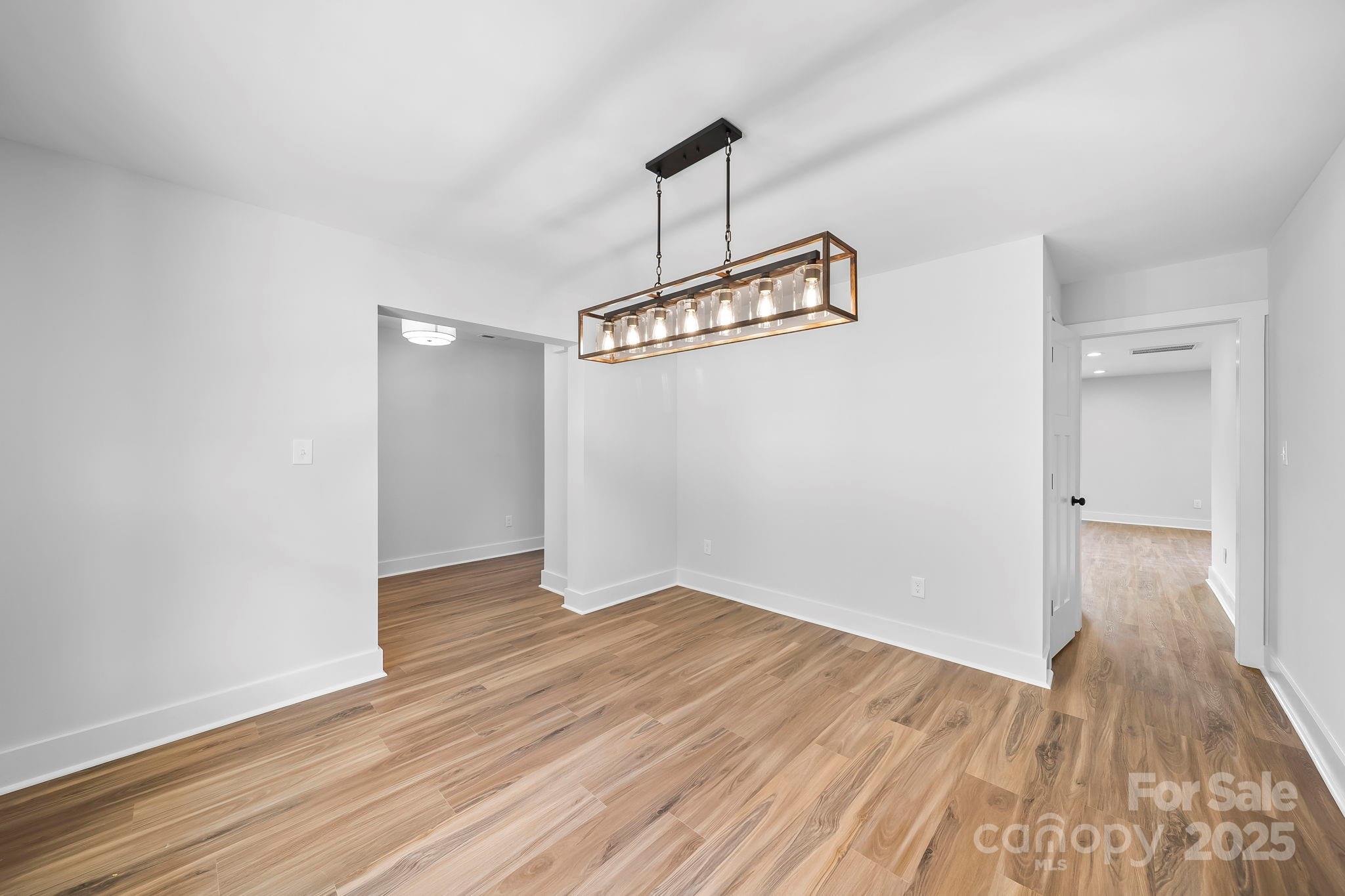 1312 Austin Chaney Road Wingate, NC 28174 - Photo 8 of 47 a view of a room with wooden floor and a ceiling fan