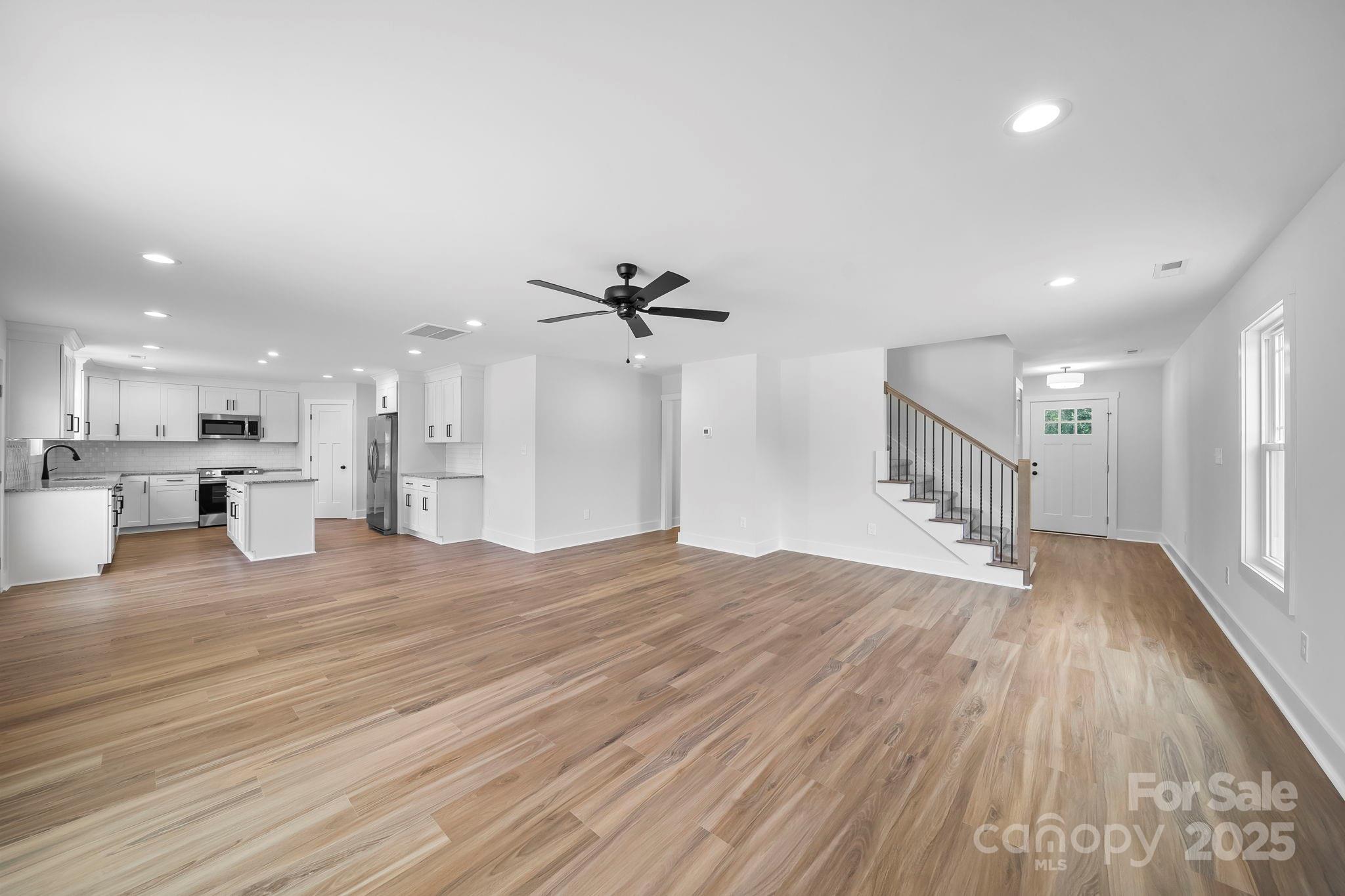 1312 Austin Chaney Road Wingate, NC 28174 - Photo 10 of 47 a view of empty room with wooden floor and windows