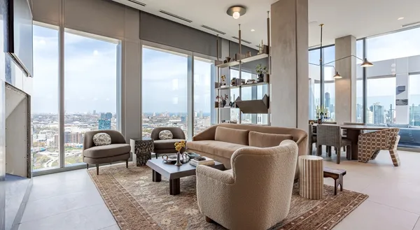 a dining room with furniture and a floor to ceiling window