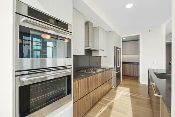 a kitchen with granite countertop a stove and a refrigerator