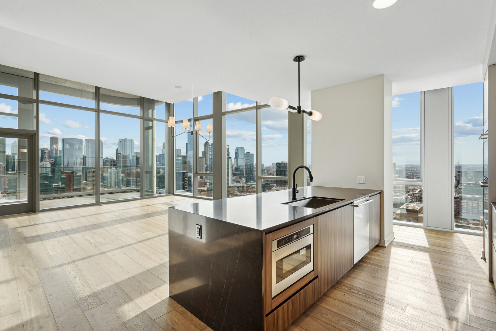1114 West Carroll Avenue, Unit PH3303 Chicago, IL 60607 - Photo 6 of 36 a large kitchen with kitchen island a large window a sink and stainless steel appliances